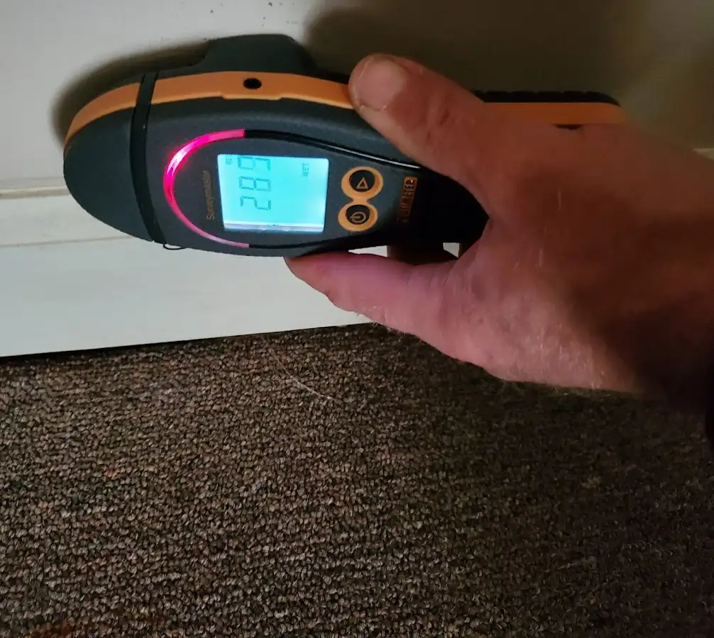 Moisture detection at baseboard during Storm Damage Restoration in Vancouver